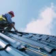 professional roofer installing metal roof on a roof photo 1
